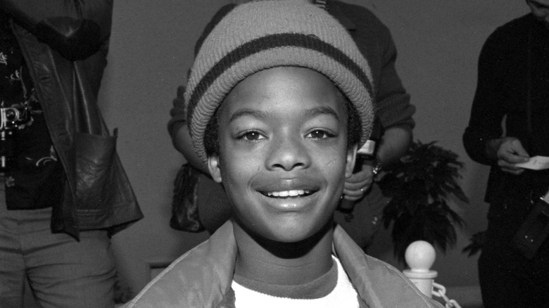 Todd Bridges smiling in a 1980s photo.