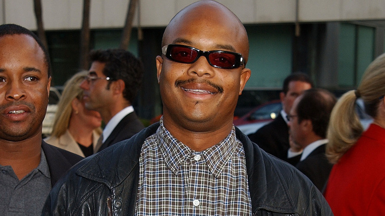Todd Bridges smiling at the "Serving Sara" premiere in 2002.