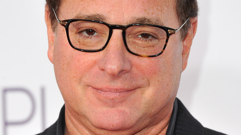 Bob Saget poses at an event