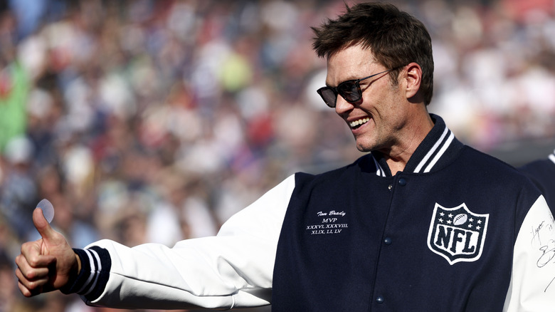 Tom Brady smiling and giving a thumbs-up