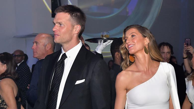 Tom Brady and Giselle Bundchen looking off to the side at a gala
