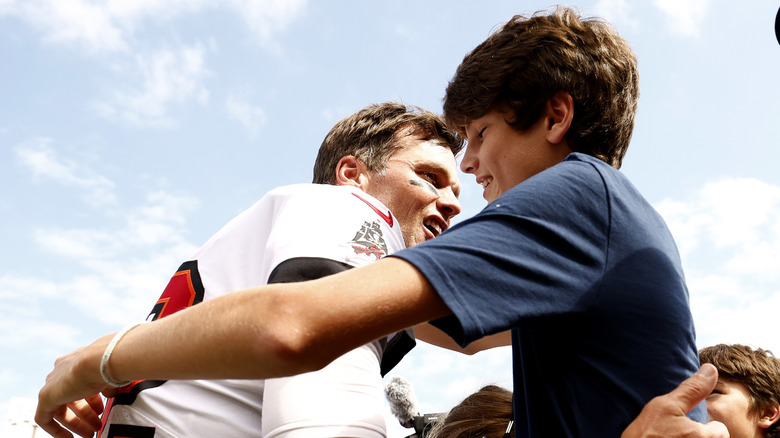 Tom Brrady hugging son Jack after game