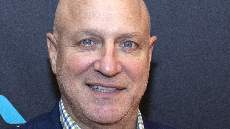 Tom Colicchio smiling blue background