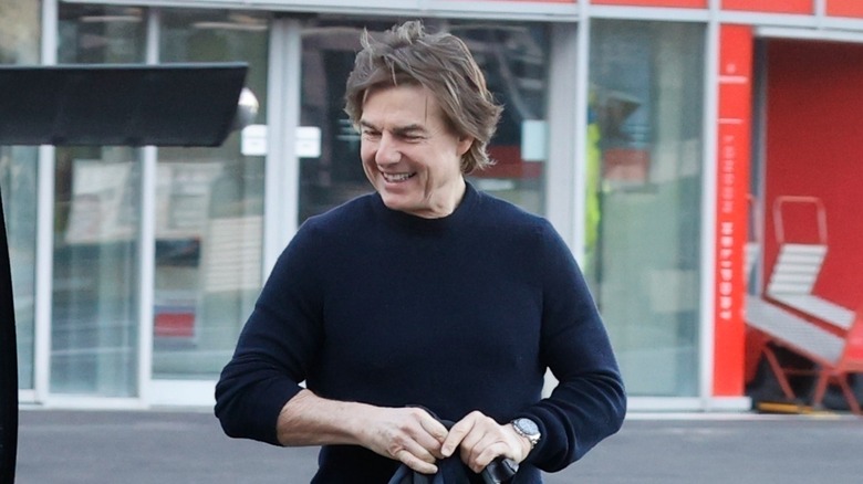 Tom Cruise smiling, walking