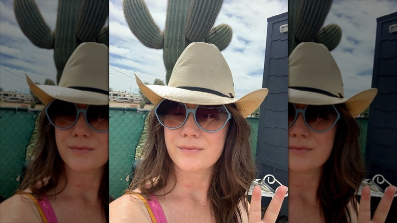 E.A. Hanks on a road trip in 2019 wearing a cowboy hat and sunglasses