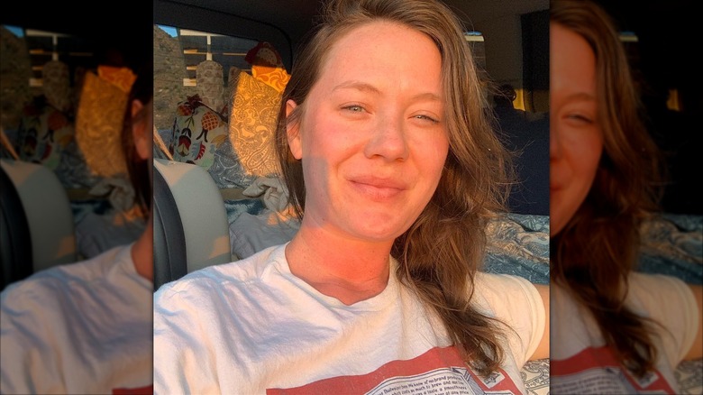 E.A. Hanks smiling and sitting in a car during a road trip in Texas