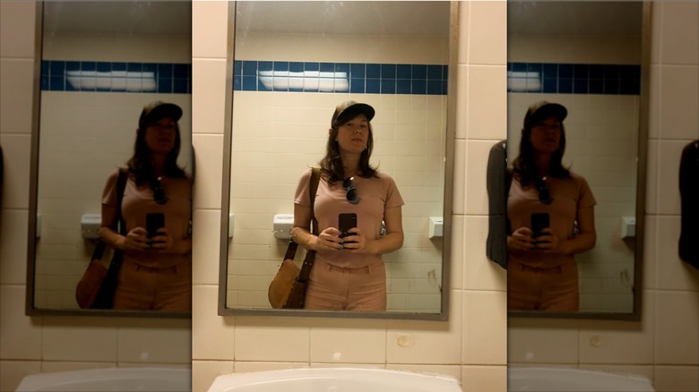 E.A. Hanks taking a mirror photo on a road trip