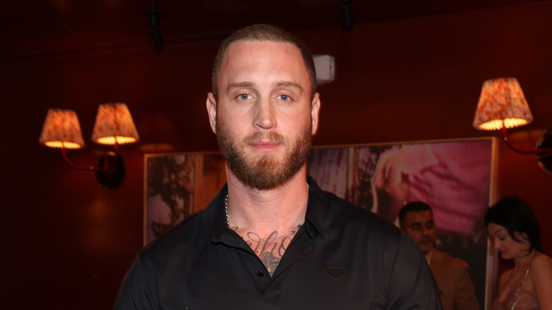 Chet Hanks posing for photos in a black shirt