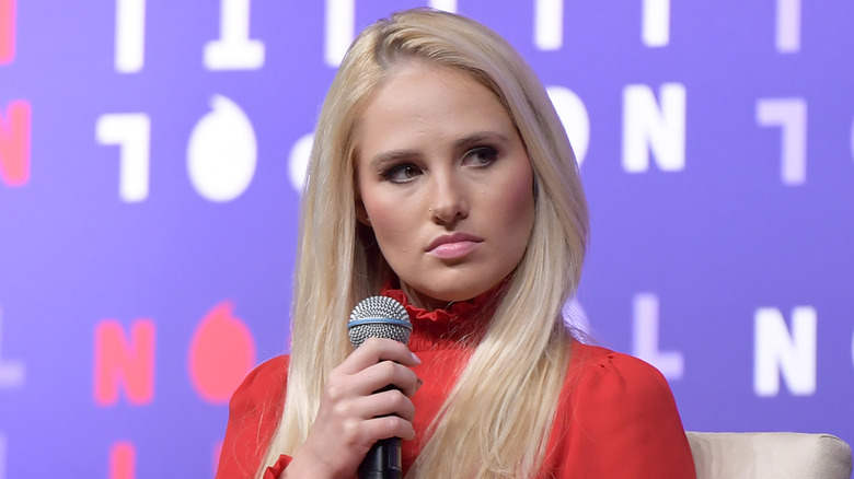 Tomi Lahren holding a microphone