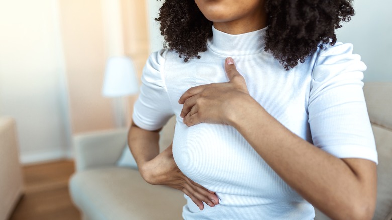 A woman doing a breast exam