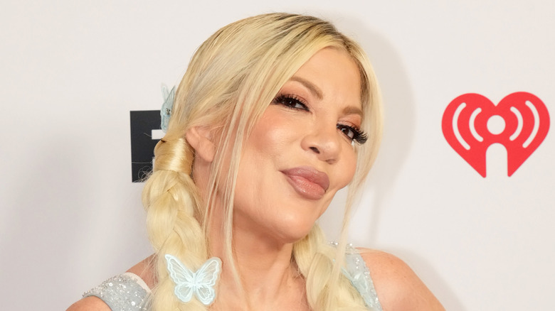 Tori Spelling with blonde hair and braids