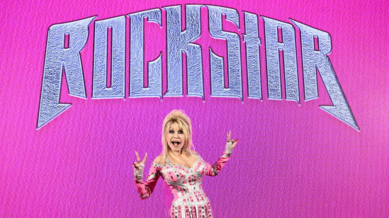 Dolly Parton posing in front of a 'Rockstar' LED screen