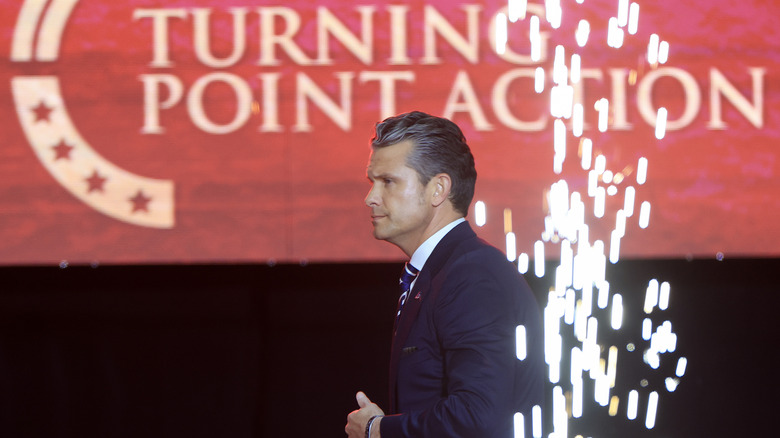 Pete Hegseth onstage with pyrotechnics during the memorial service for political activist Charlie Kirk at State Farm Stadium on September 21, 2025