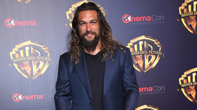 Jason Momoa smiling at CinemaCon in 2018