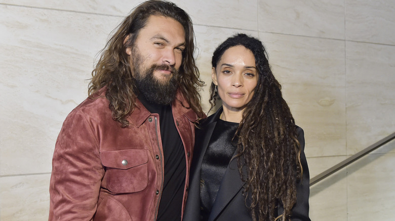 Jason Momoa and Lisa Bonet smiling at the Tom Ford Autumn/Winter show in 2020