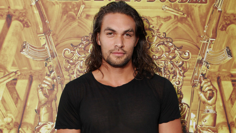 Jason Momoa smiling at a screening of "The Devil's Double" in 2011