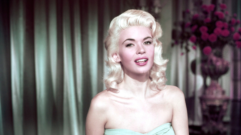 Jayne Mansfield wearing her signature blonde hair and strapless green gown