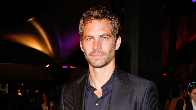 Paul Walker in a navy shirt with black blazer