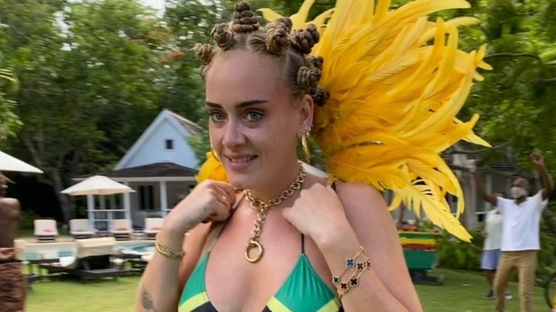 Adele wearing Bantu knots and a Jamaican flag bikini