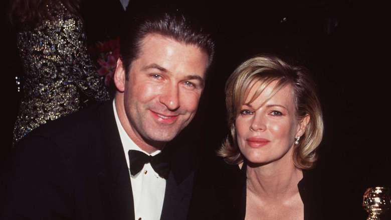 Alec Baldwin and Kim Basinger sitting together smiling