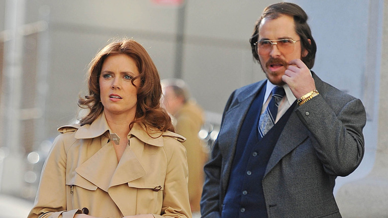 Amy Adams and Cristian Bale on the 2013 set of "American Hustle"