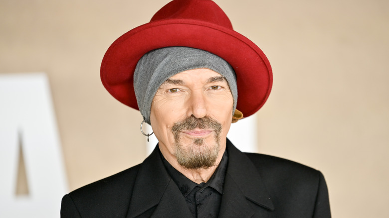 Billy Bob Thornton posing for photos in a big red hat