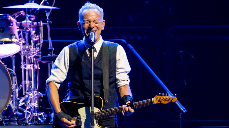 Bruce Springsteen singing and playing the guitar