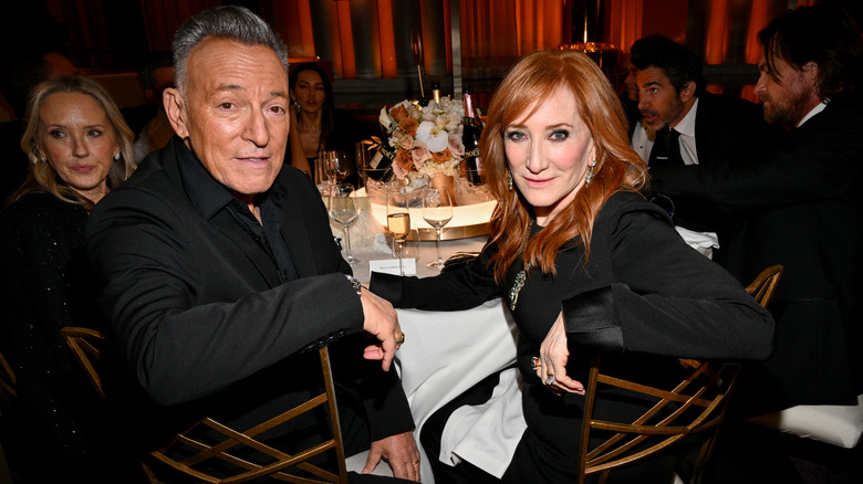 Patti Scialfa and Bruce Springsteen posing for photos