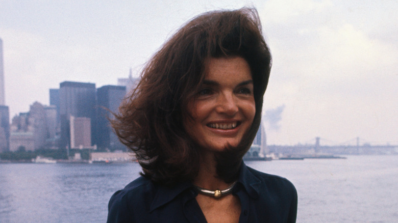 Jackie Onassis in front of the New York City skyline in the 1970s