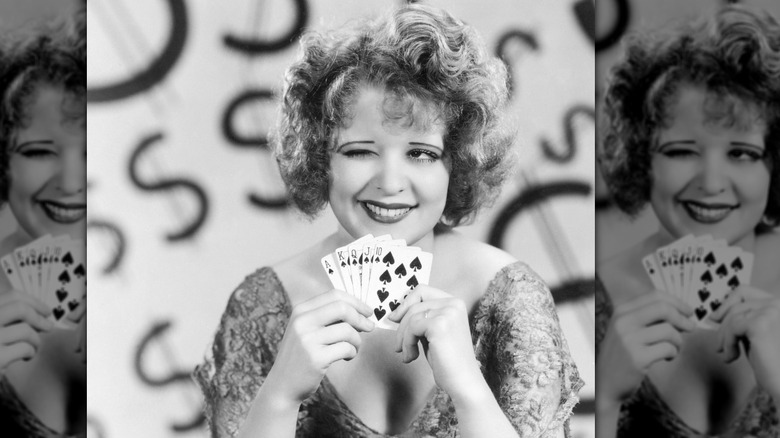 Clara Bow winking and showing she has a royal flush