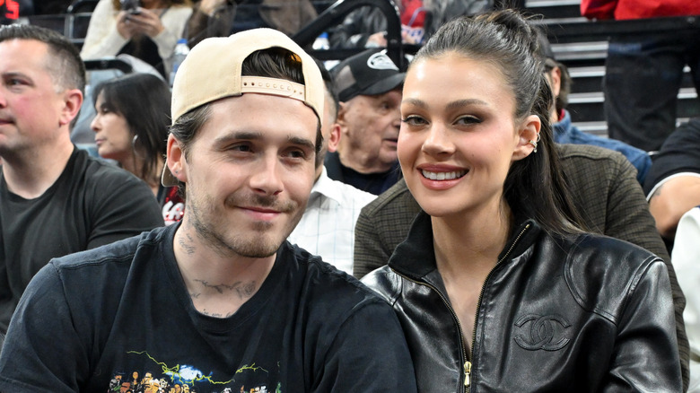 Nicola Peltz Beckham and Brooklyn Peltz Beckham at a sports event