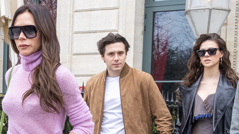 Victoria Beckham, Brooklyn Peltz Beckham, and Nicola Peltz Beckham leaving hotel while being photographed by paparazzi