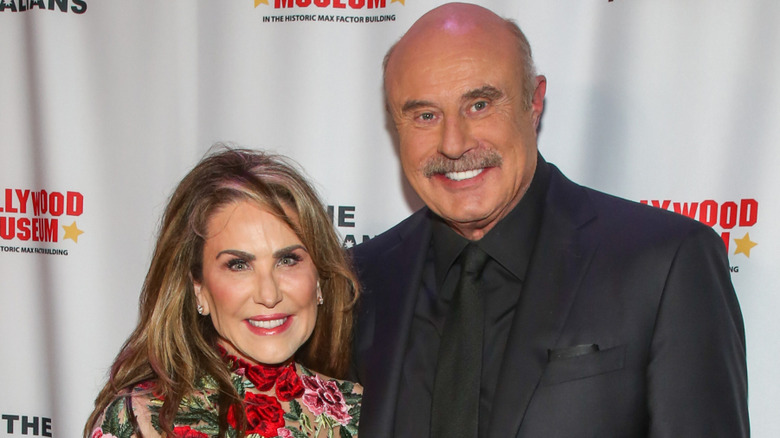 Dr. Phil and Robin McGraw smiling at event