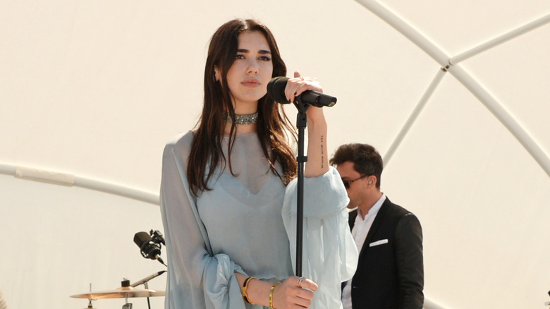 Dua Lipa singing at a luncheon in 2016