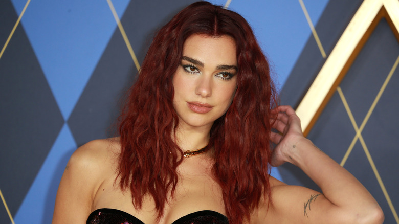 Dua Lipa posing with red hair at Argyle premiere