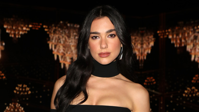 Dua Lipa wearing a black dress at an awards event
