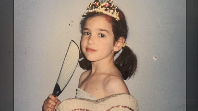 Dua Lipa dressed up in a tiara as a kid