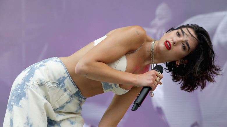 Dua Lipa dancing on stage at a music festival in 2018