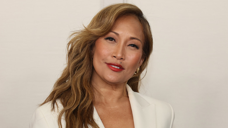 Carrie Ann Inaba wearing a cream suit jacket