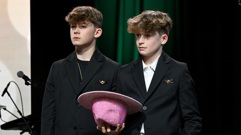 Elton John's sons, Zachary and Elijah, stand onstage
