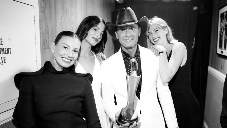 Faith Hill, Audrey McGraw, Tim McGraw, and Maggie McGraw posing backstage
