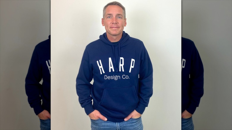 Clint Harp wears a branded hoodie from Harp Design Co.