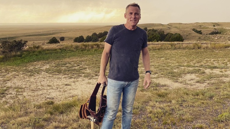 Clint Harp poses in a Colorado field.