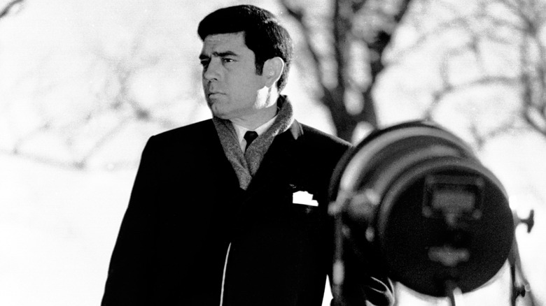 CBS television newsman Dan Rather broadcasts from outside the National Cathedral in Washington, D.C., during the funeral for former president Dwight Eisenhower on March 31, 1969.