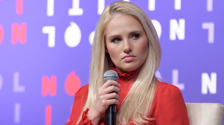 Tomi Lahren on stage with a microphone