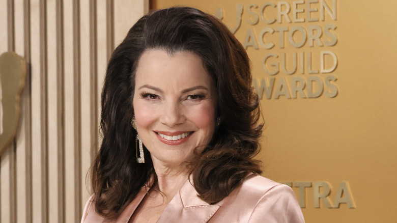 Fran Drescher smiling in a light pink suit at the Screen Actor Guild Awards.