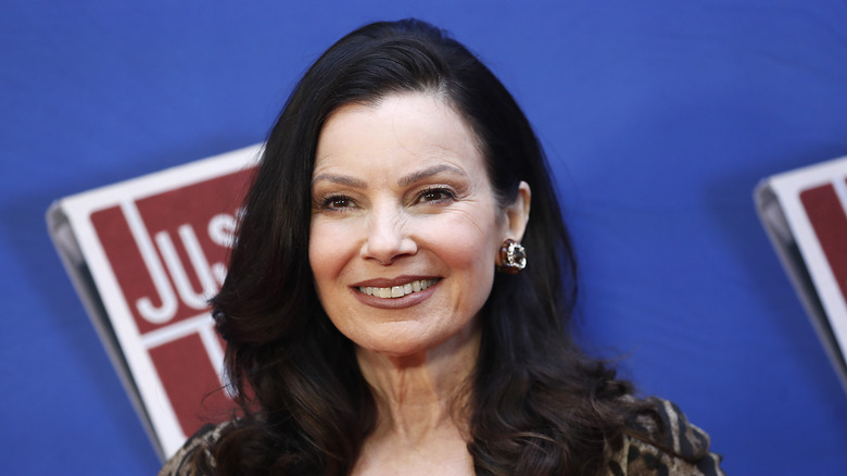 Fran Drescher smiling in a brown leopard-spotted dress.