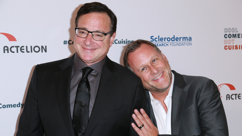 Bob Saget and Dave Coulier smiling on step-and-repeat