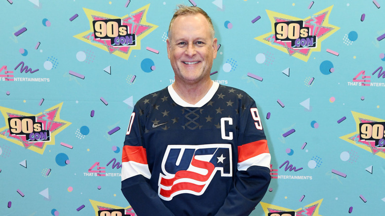 Dave Coulier smiling at 90s Con step-and-repeat