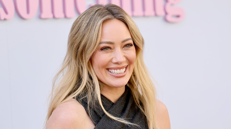 Hilary Duff smiling in a black top